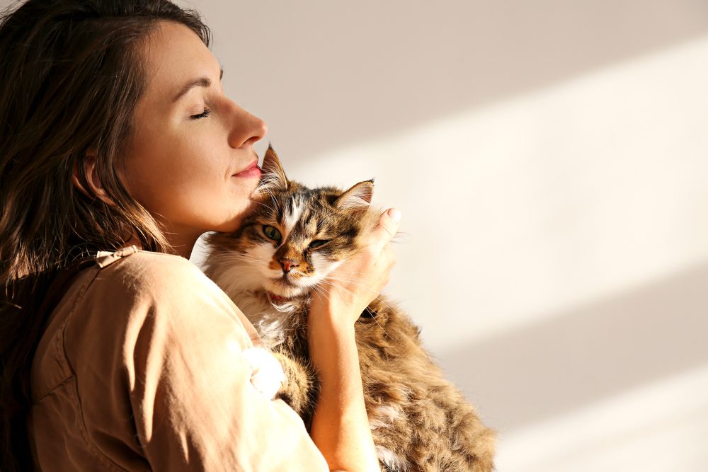 young woman holding cat